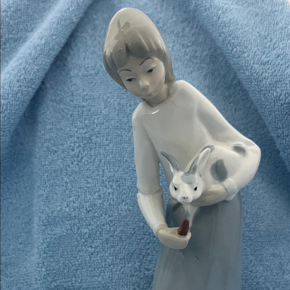figurine of a girl with a rabbit.